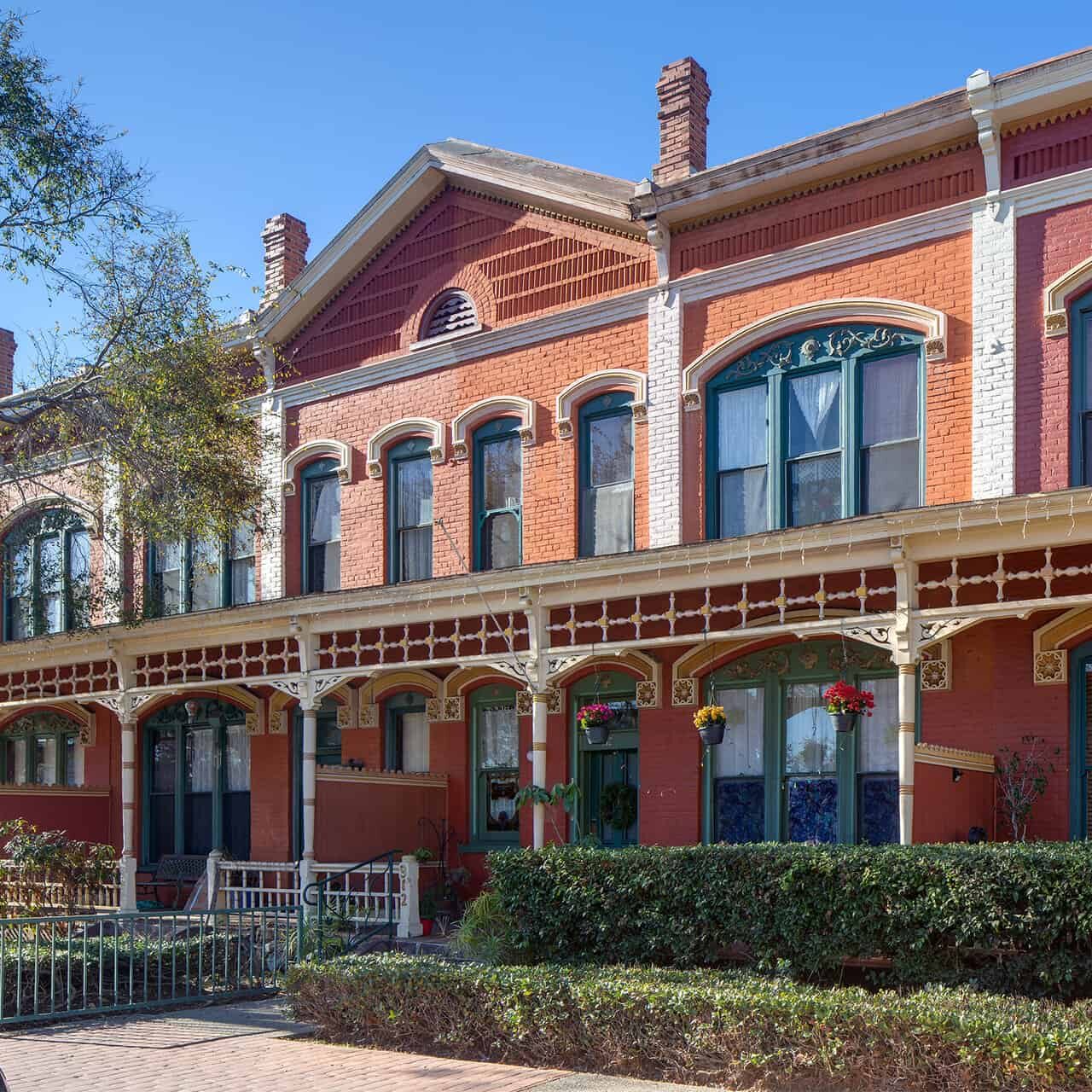 The exterior of a Victorian brick row house from the late 1800's in National City