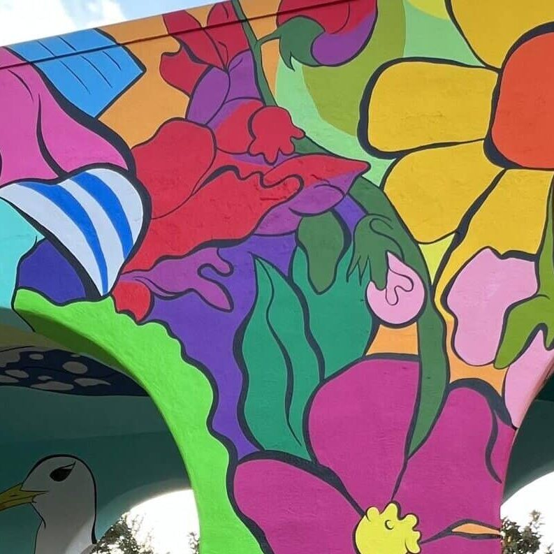 A brightly colored floral mural painted on an archway at Liberty Station.