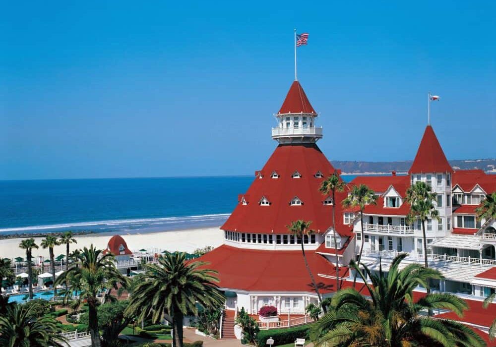 The iconic red roof of the Hotel del Coronado set against the background of the Pacific Ocean.