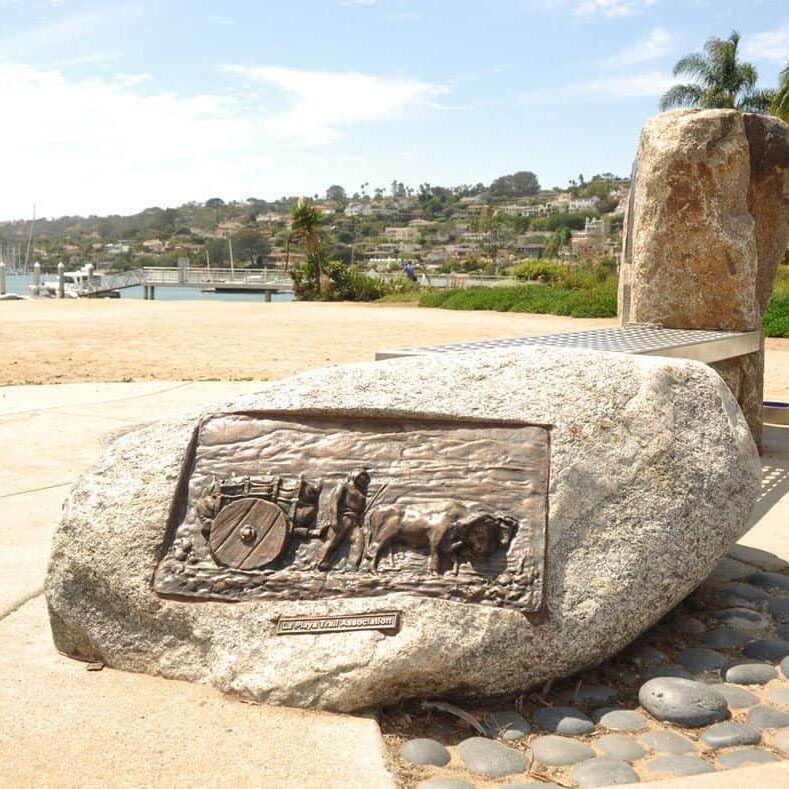 A picture of a rock with a sign carved into it along the La Playa Trails Walking Tour