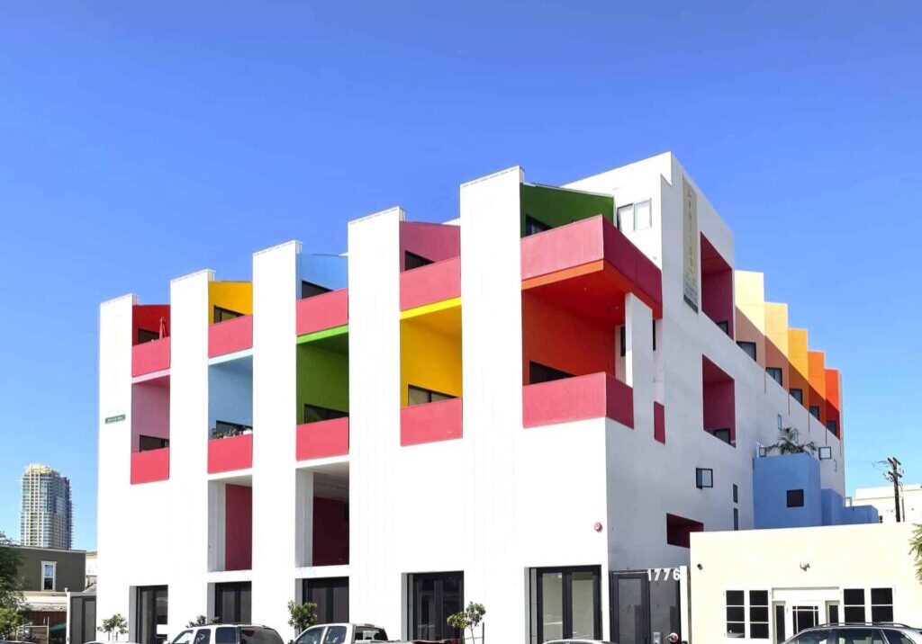 White and red building with modern architecture, with a blue sky background