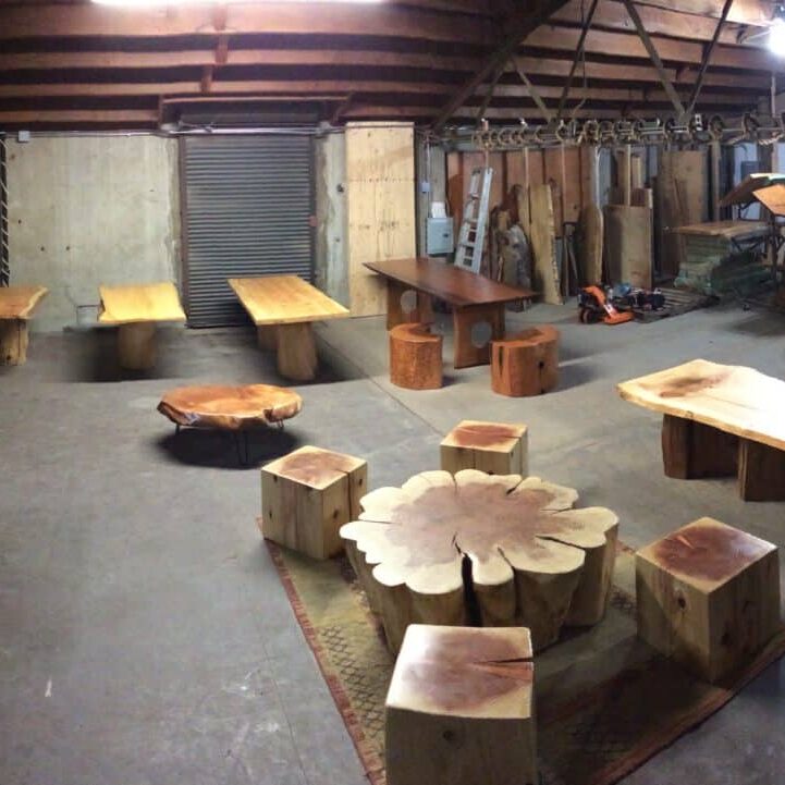a large, open room with tables and chairs made out of reclaimed wood