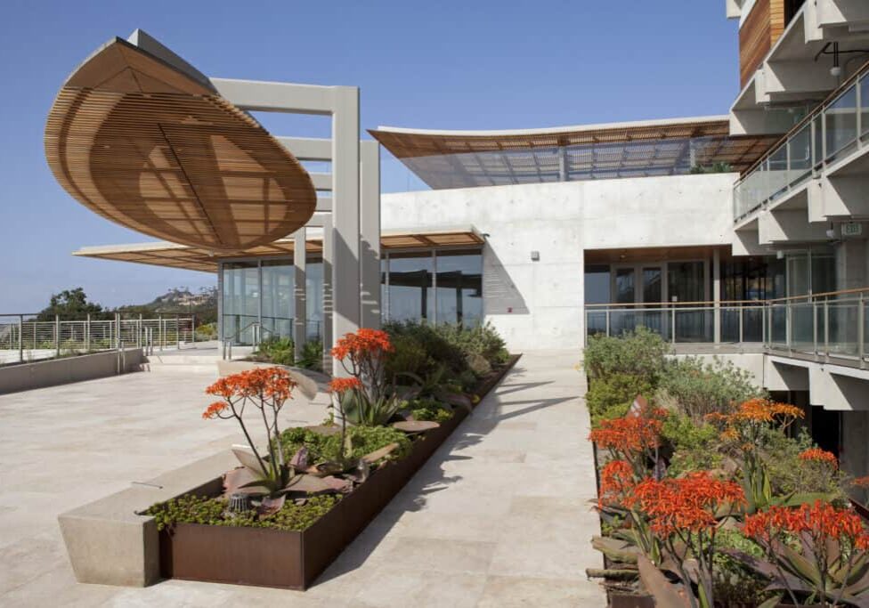The Scripps Conservation Facility is a modern seaside building landscaped with vibrant native plants.