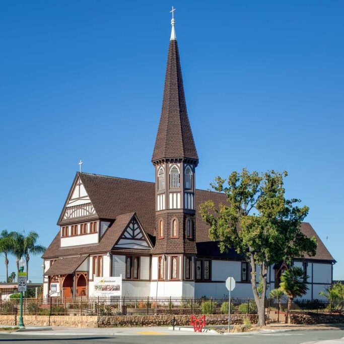 Victorian-era church set against a blue sky