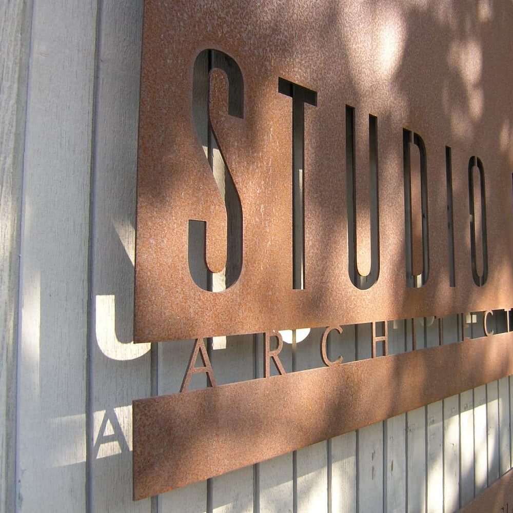 A bronze sign engraved with the Studio E Architects logo
