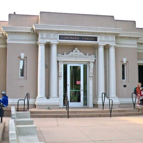 Front facade of historic building in Coronado, CA, featuring Roman style columns and architecture.
